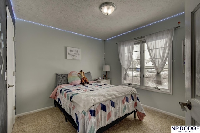 bedroom with light colored carpet and a textured ceiling