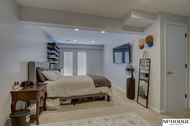 bedroom with french doors and light colored carpet