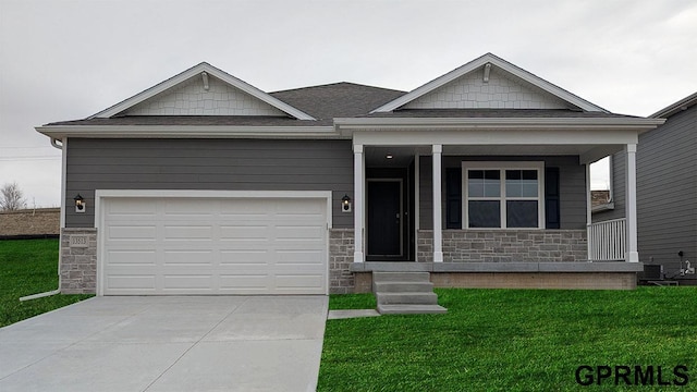 18368 Cary St, Gretna, NE 68136 - view of front of house with stone siding, driveway, a front lawn, and an attached garage