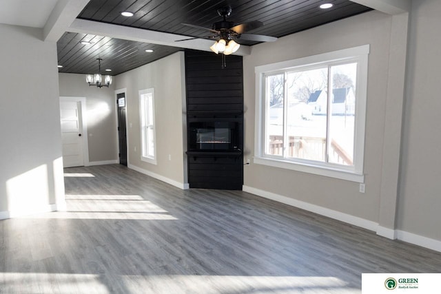 unfurnished living room with ceiling fan with notable chandelier, hardwood / wood-style floors, wooden ceiling, and a fireplace