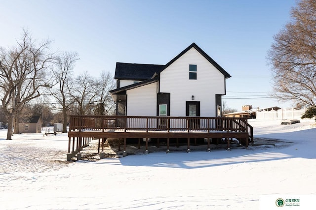 snow covered property featuring a deck