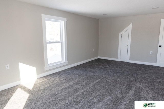 empty room with dark carpet