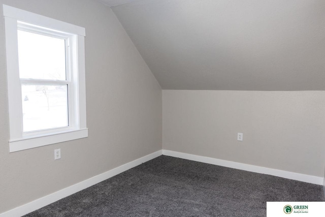 bonus room featuring carpet flooring and vaulted ceiling