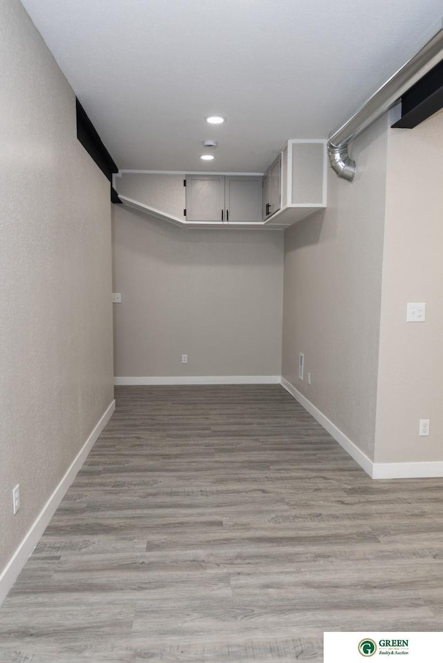 basement with light hardwood / wood-style floors