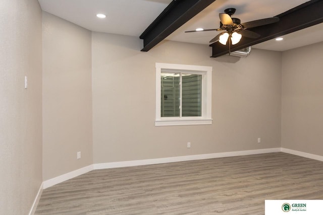 spare room with ceiling fan, beam ceiling, and light hardwood / wood-style floors