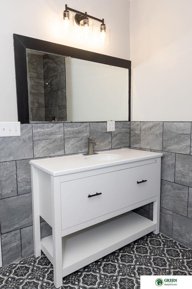 bathroom featuring vanity and tile walls