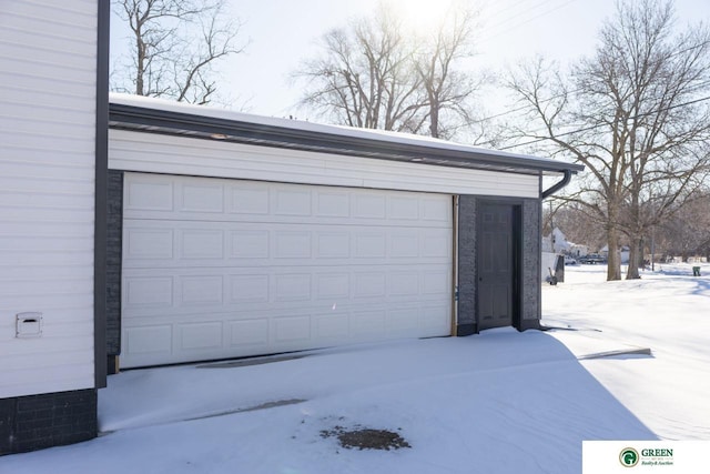 view of snow covered garage