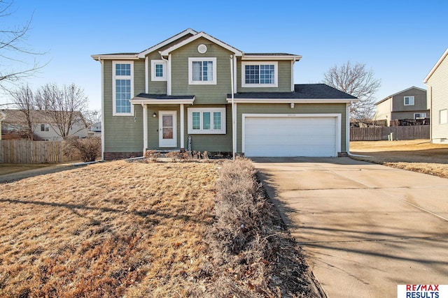 traditional-style home featuring driveway and fence