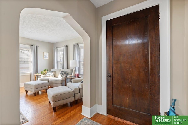 entrance foyer featuring hardwood / wood-style flooring and a textured ceiling