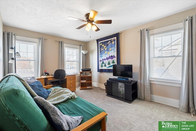 living room featuring ceiling fan, carpet floors, and a textured ceiling