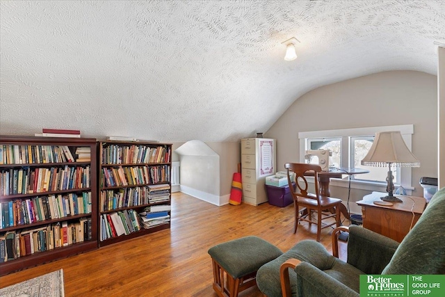 office space with lofted ceiling, wood-type flooring, and a textured ceiling