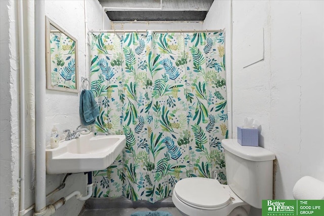 bathroom featuring walk in shower and toilet