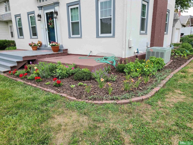 exterior space with a lawn and central air condition unit