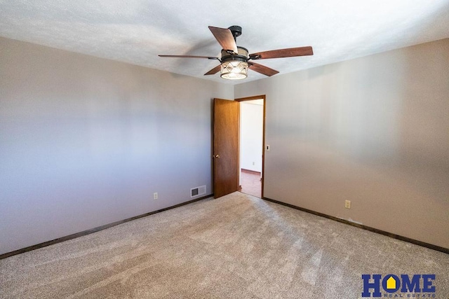 empty room with light carpet and ceiling fan