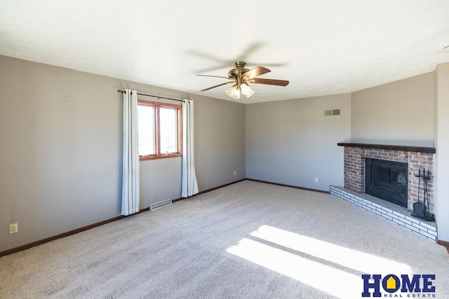 unfurnished living room with ceiling fan, light colored carpet, and a fireplace