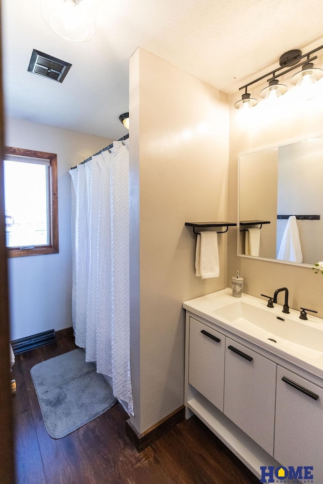 bathroom featuring vanity, hardwood / wood-style floors, and ceiling fan