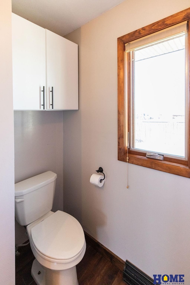 bathroom featuring hardwood / wood-style flooring and toilet