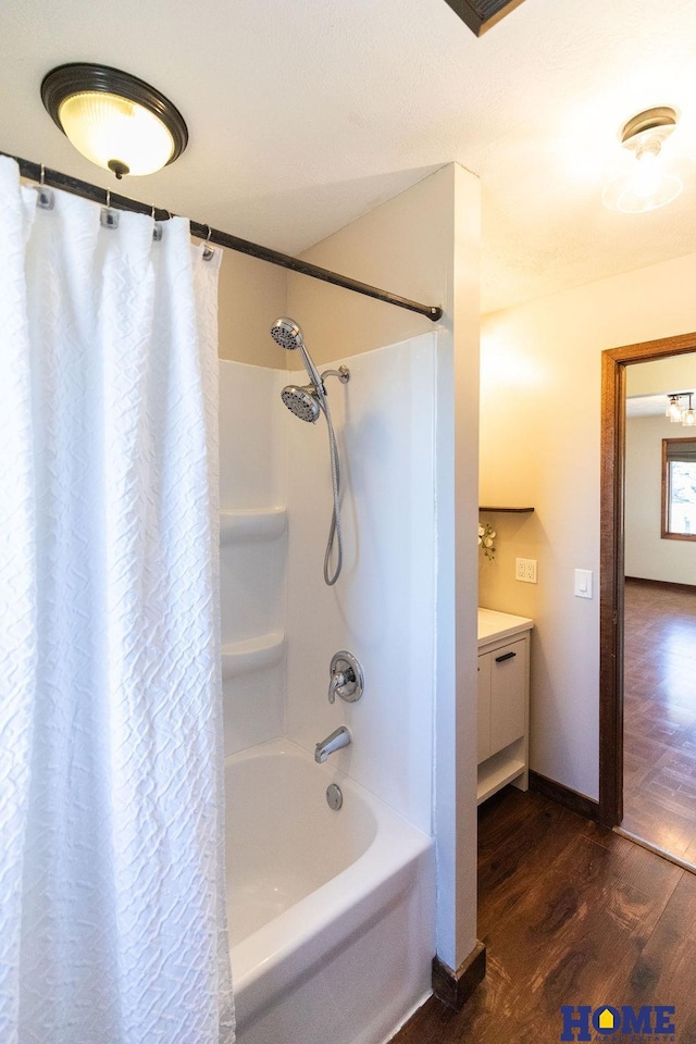 bathroom with wood-type flooring, vanity, and shower / bath combo with shower curtain