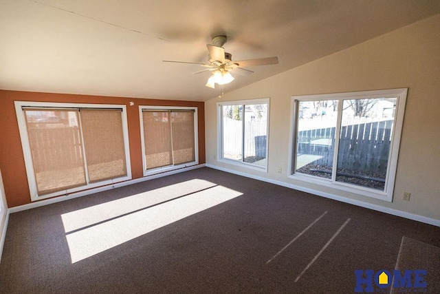 unfurnished bedroom featuring dark carpet, vaulted ceiling, and ceiling fan