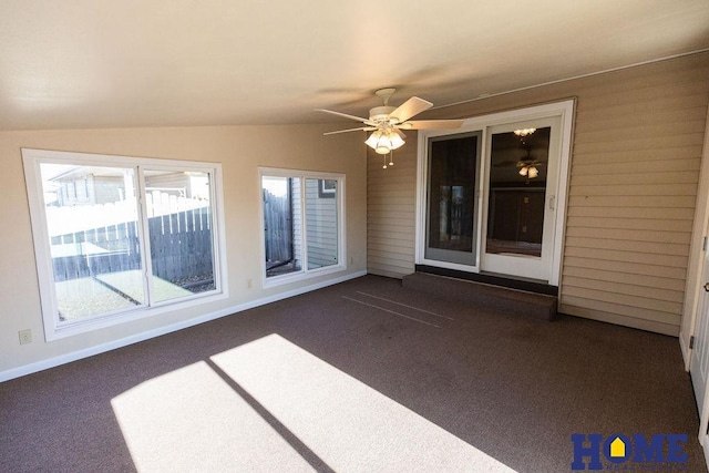 unfurnished sunroom with lofted ceiling and ceiling fan