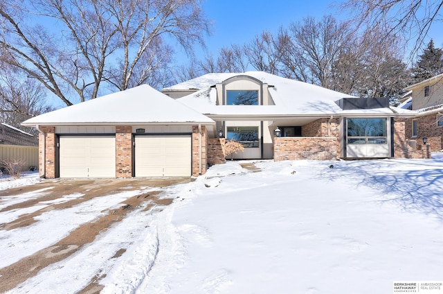 view of front of house featuring a garage and brick siding