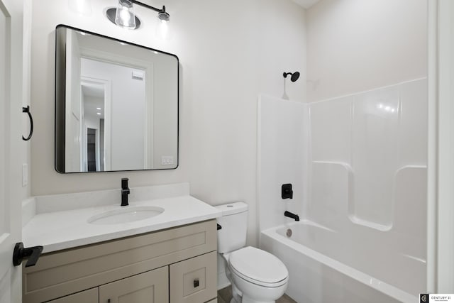 full bathroom featuring vanity, washtub / shower combination, and toilet