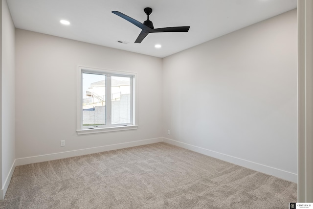 spare room featuring ceiling fan and carpet flooring