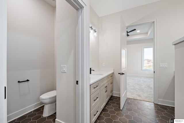 bathroom with vanity, toilet, and tile patterned flooring