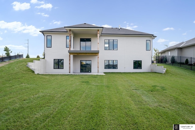 rear view of property with a yard