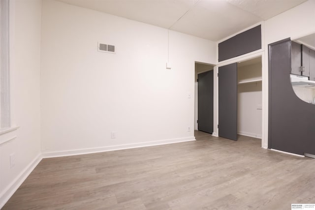 unfurnished room with light wood-type flooring