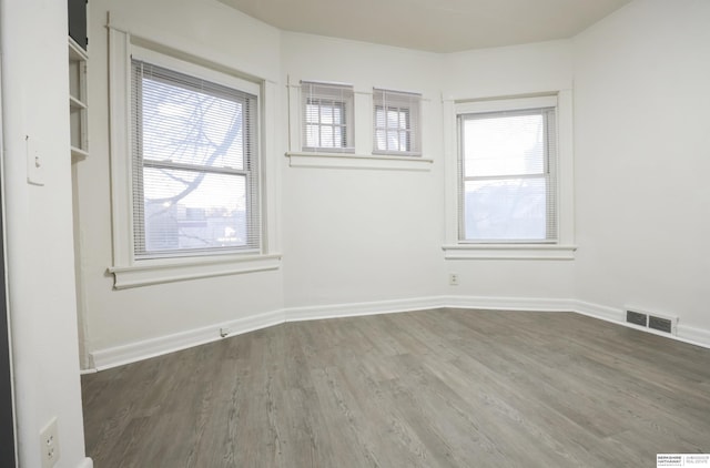 empty room with dark hardwood / wood-style flooring