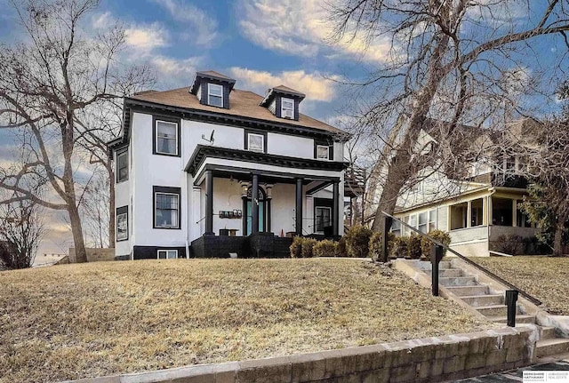 view of front of house with a lawn and covered porch