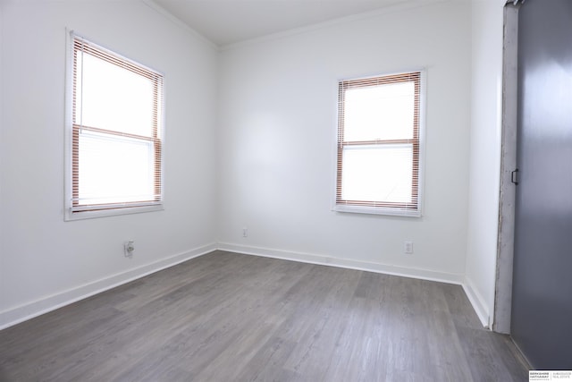 empty room featuring crown molding and dark wood-type flooring