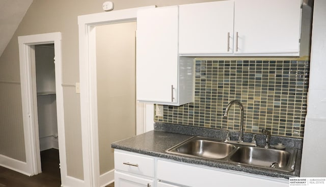 kitchen with white cabinetry, sink, and decorative backsplash