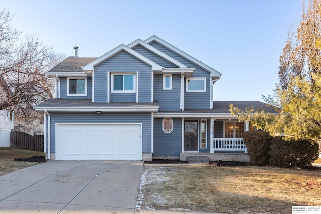 view of front of property with a garage, a front yard, and covered porch