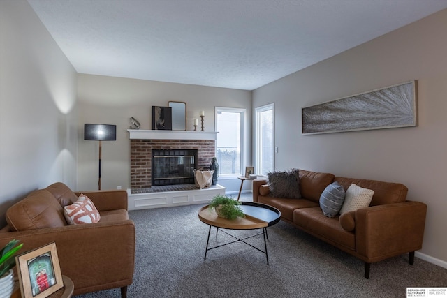 carpeted living room with a brick fireplace