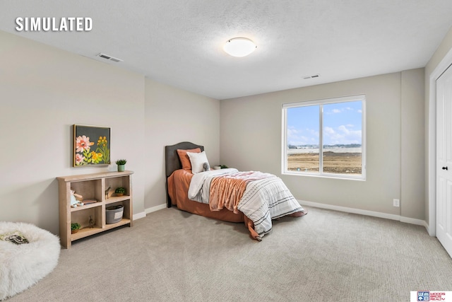 bedroom featuring carpet floors and a textured ceiling