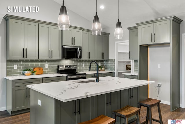 kitchen featuring stainless steel range with electric stovetop, decorative light fixtures, light stone counters, and an island with sink