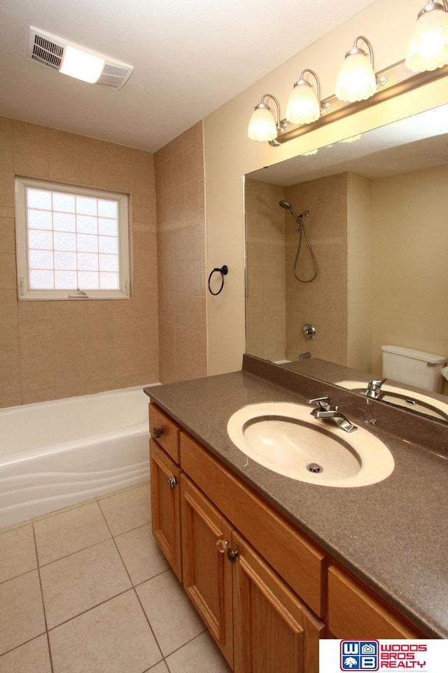 bathroom featuring toilet, visible vents, vanity,  shower combination, and tile patterned floors