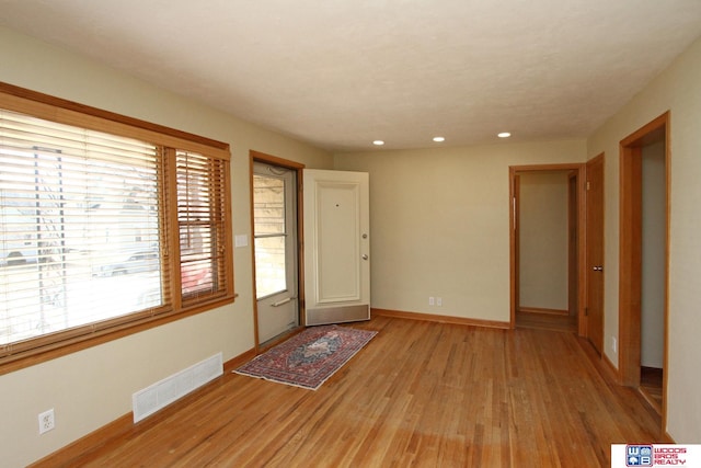 entrance foyer with light wood-type flooring, baseboards, visible vents, and recessed lighting