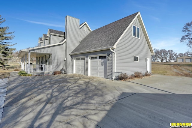 view of property exterior featuring a porch and a garage