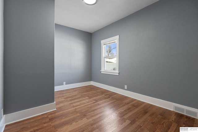 spare room with hardwood / wood-style flooring