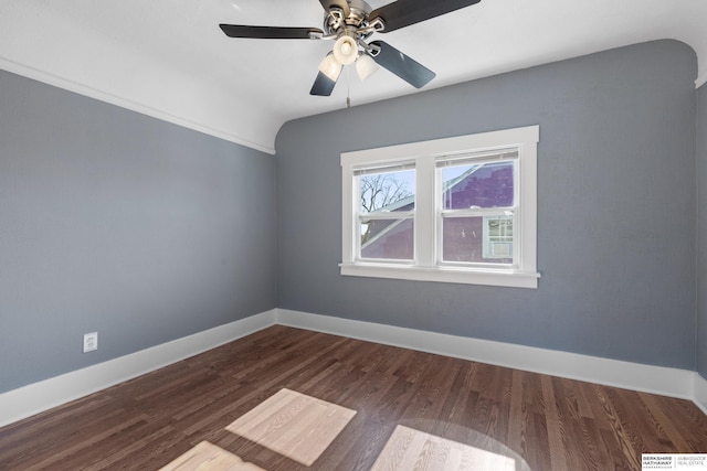 spare room with lofted ceiling, dark wood-type flooring, and ceiling fan