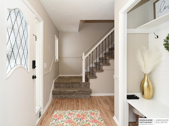 interior space with a textured ceiling and light wood-type flooring