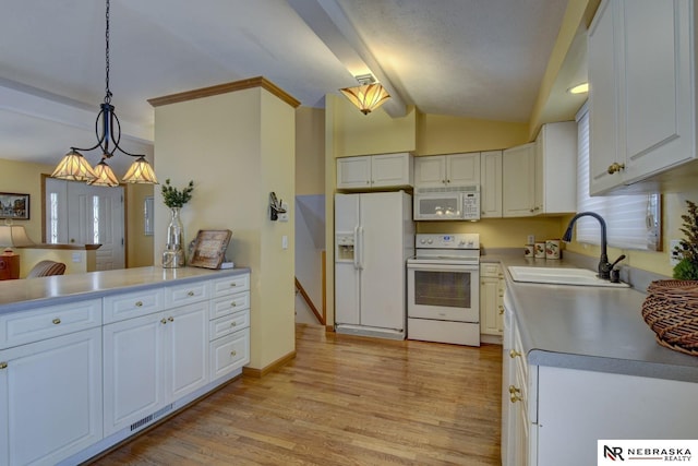 kitchen featuring pendant lighting, white appliances, sink, and white cabinets