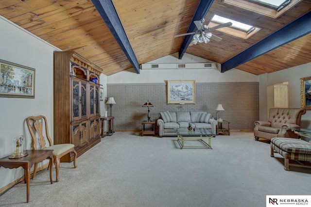 living room featuring brick wall, vaulted ceiling with skylight, and carpet floors