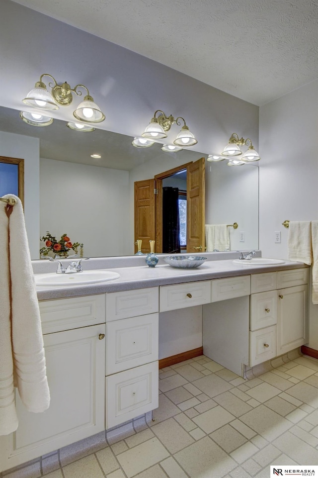 bathroom with vanity and a textured ceiling