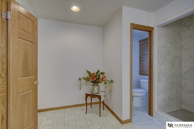 interior space featuring toilet and a tile shower