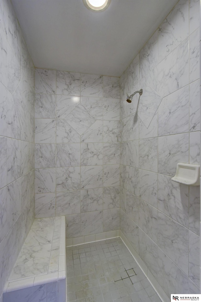 bathroom featuring a tile shower