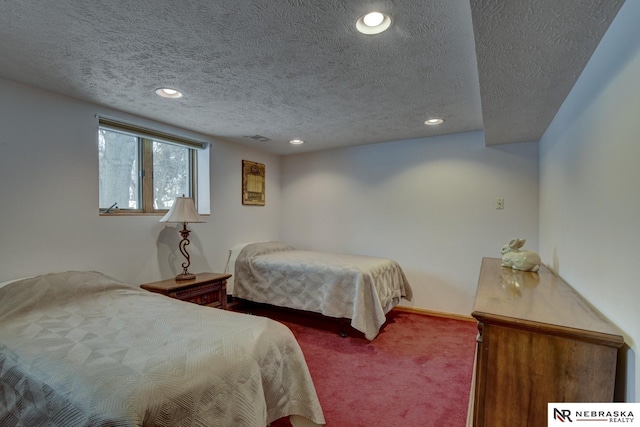 carpeted bedroom with a textured ceiling